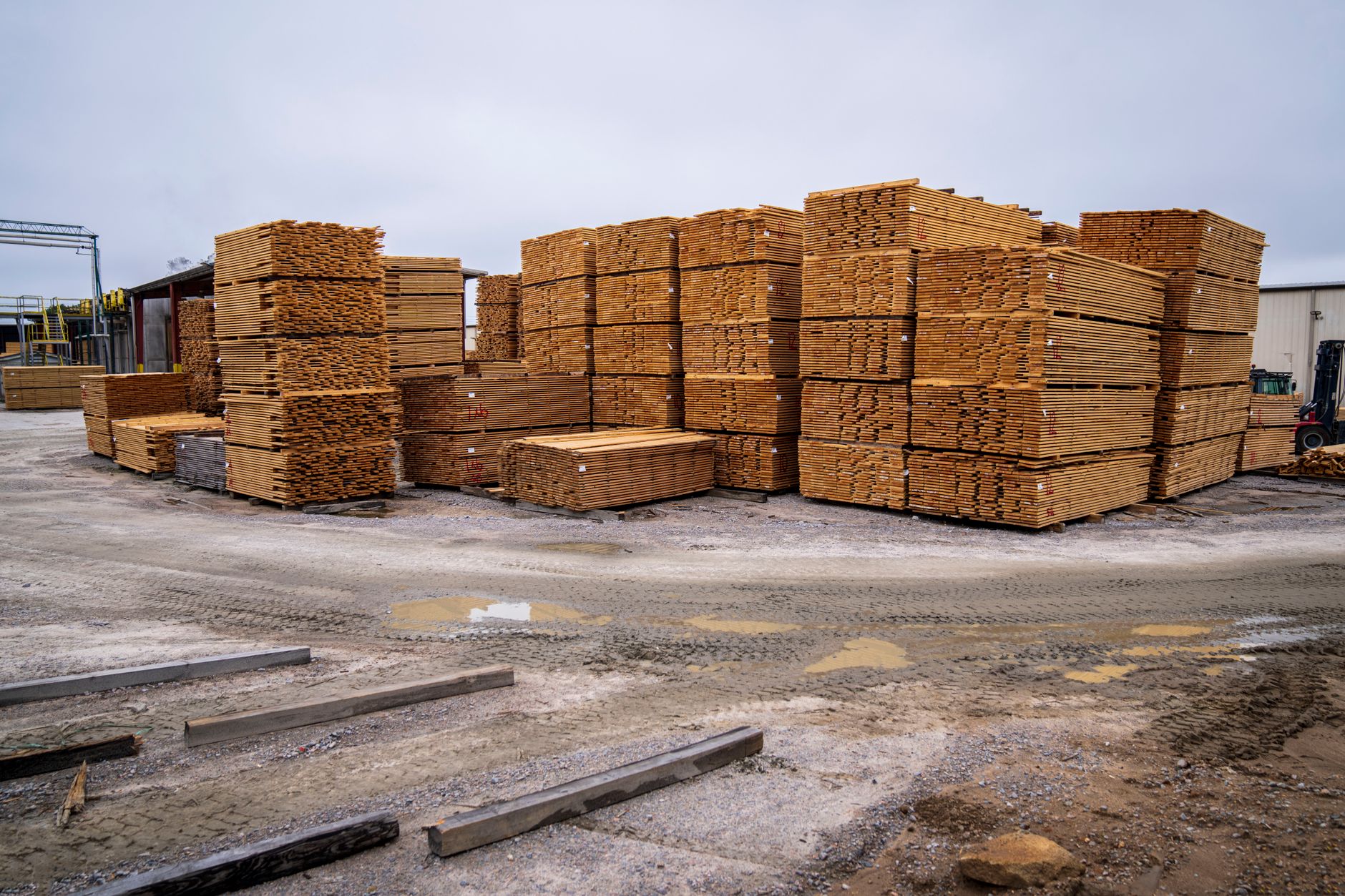 Piles of wooden planks prepared for distribution in an outdoor industrial site
